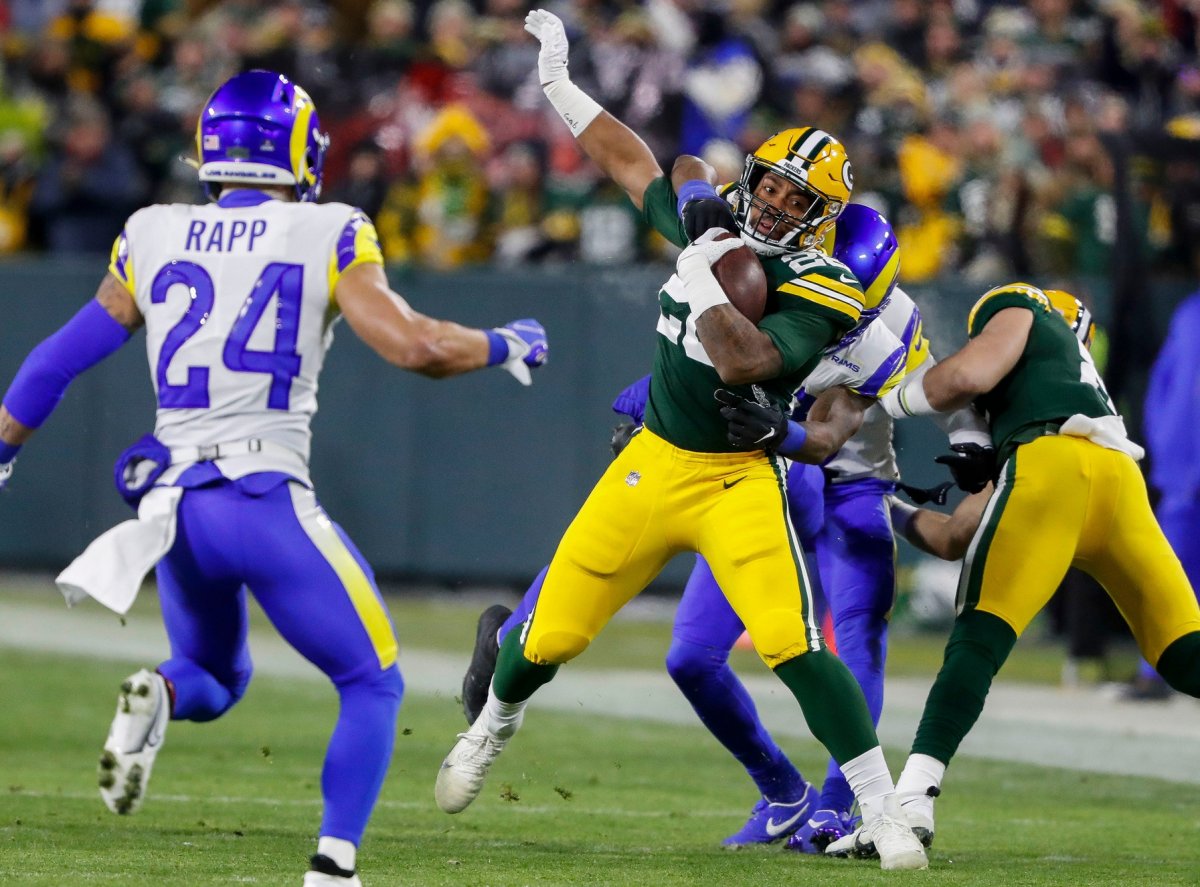Packers RB AJ Dillon evades a tackler in the Packers 24-12 win Monday.